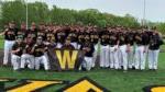 29 BHC baseball players on field smiling at camera with W banner